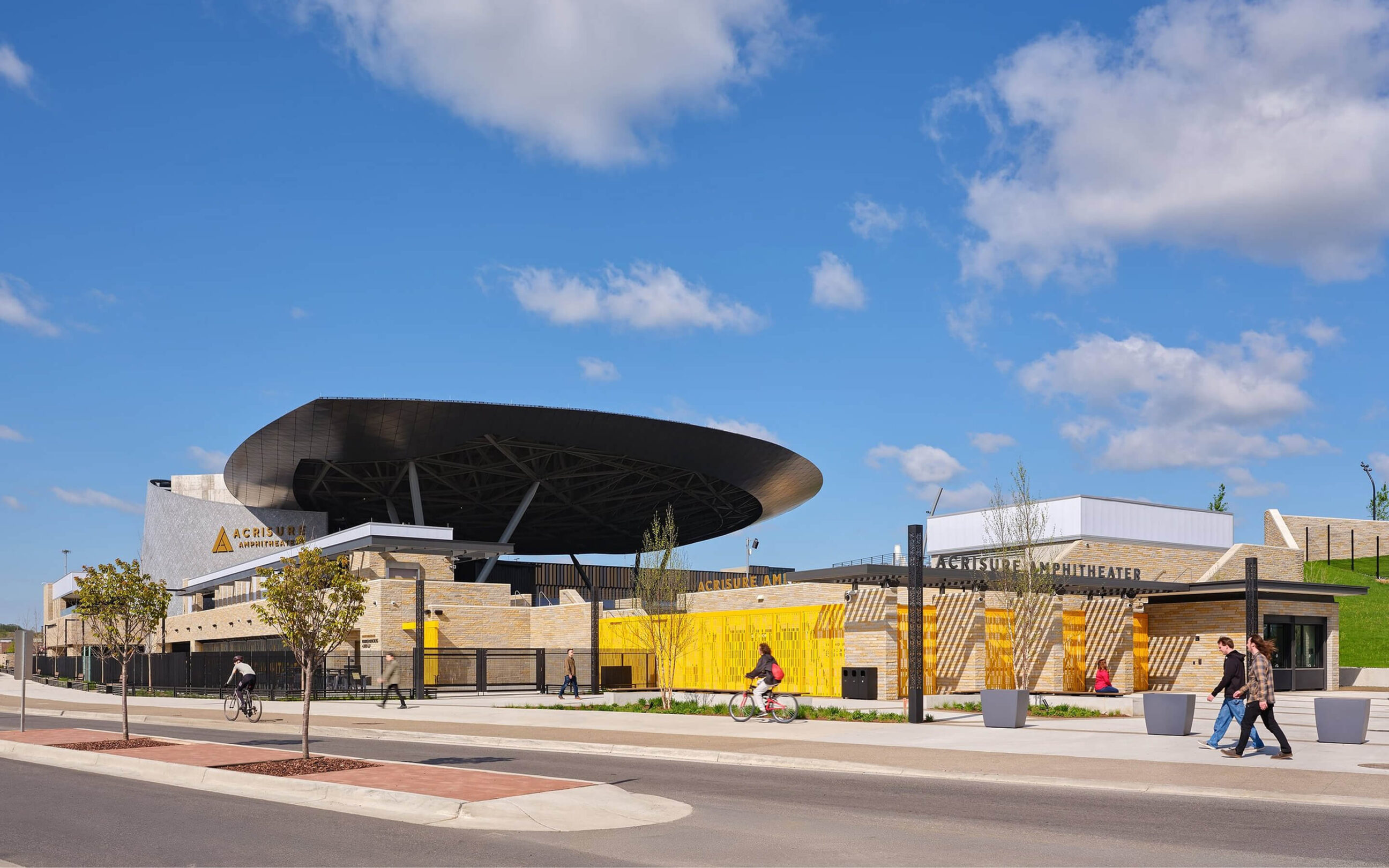 Exterior view of Acrisure Amphitheater showcasing the main entrance, architectural signage, and wayfinding elements.