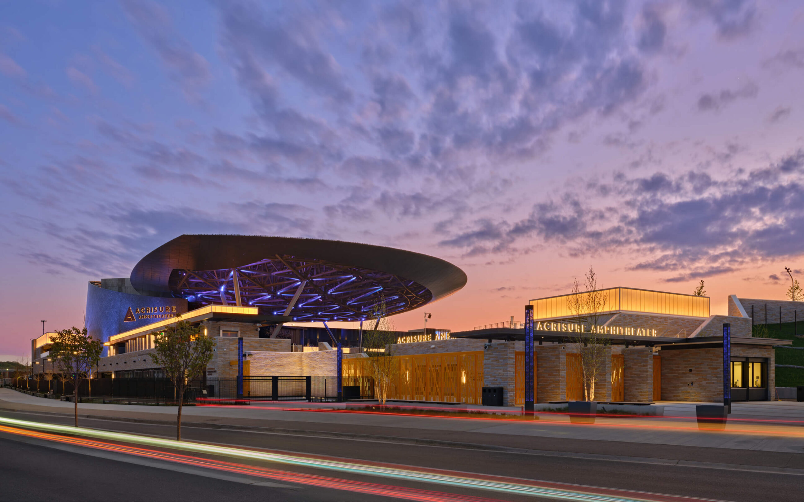Illuminated Acrisure Amphitheater entrance signage and architectural wayfinding design creating a prominent gateway to the entertainment venue.