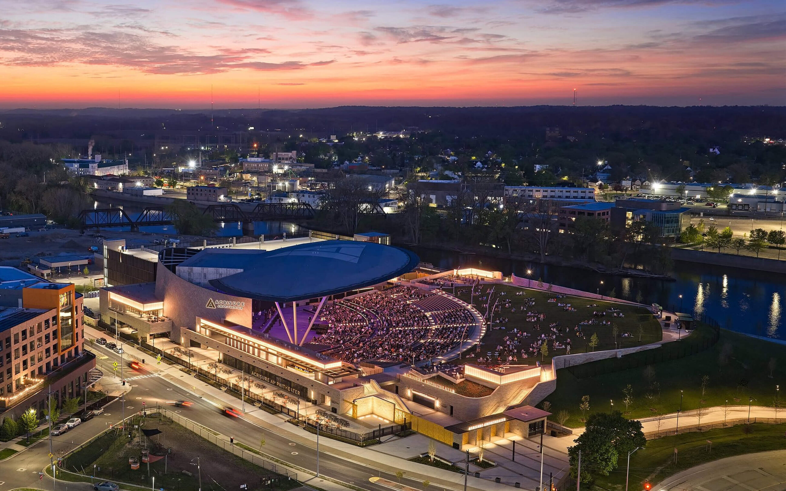 Aerial view showcasing the integrated signage and wayfinding system for Acrisure Amphitheater within the surrounding riverfront district.