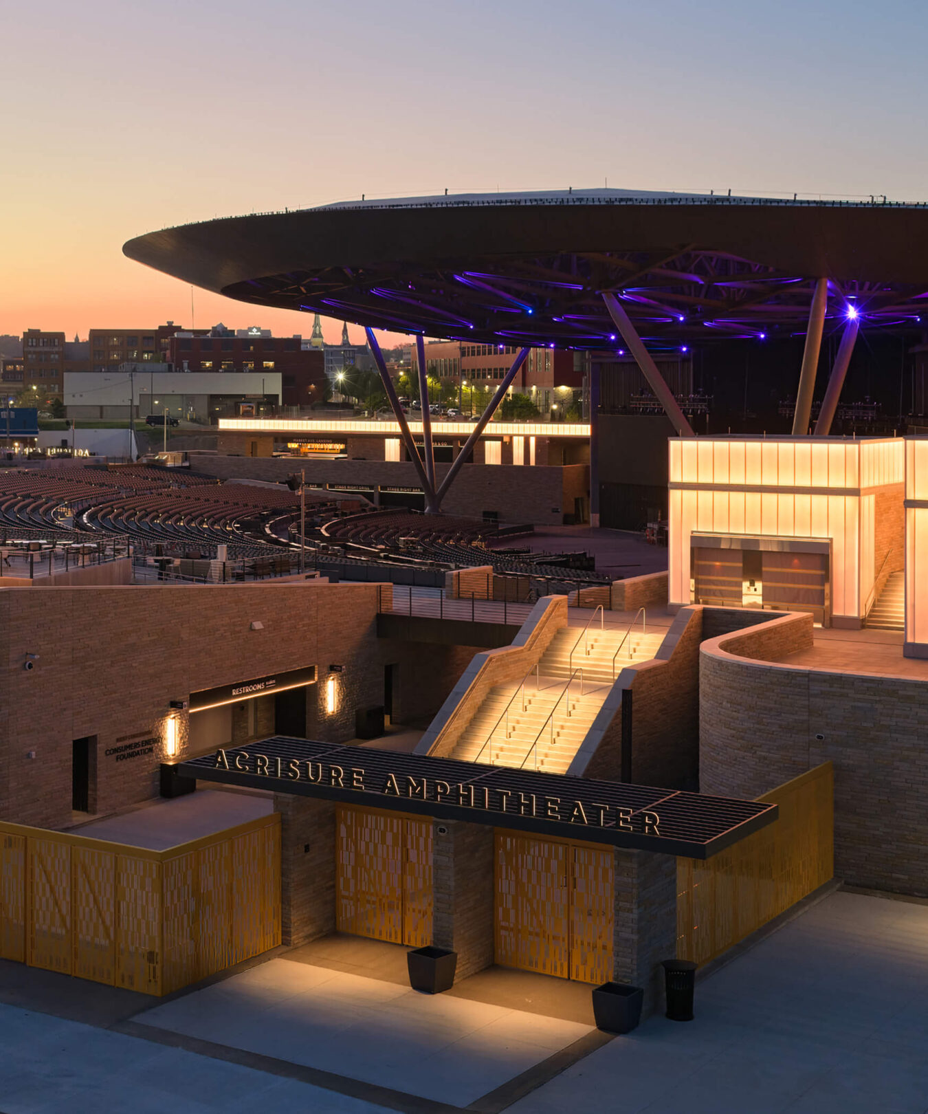 Acrisure Amphitheater exterior at Dusk showing signage and wayfinding.