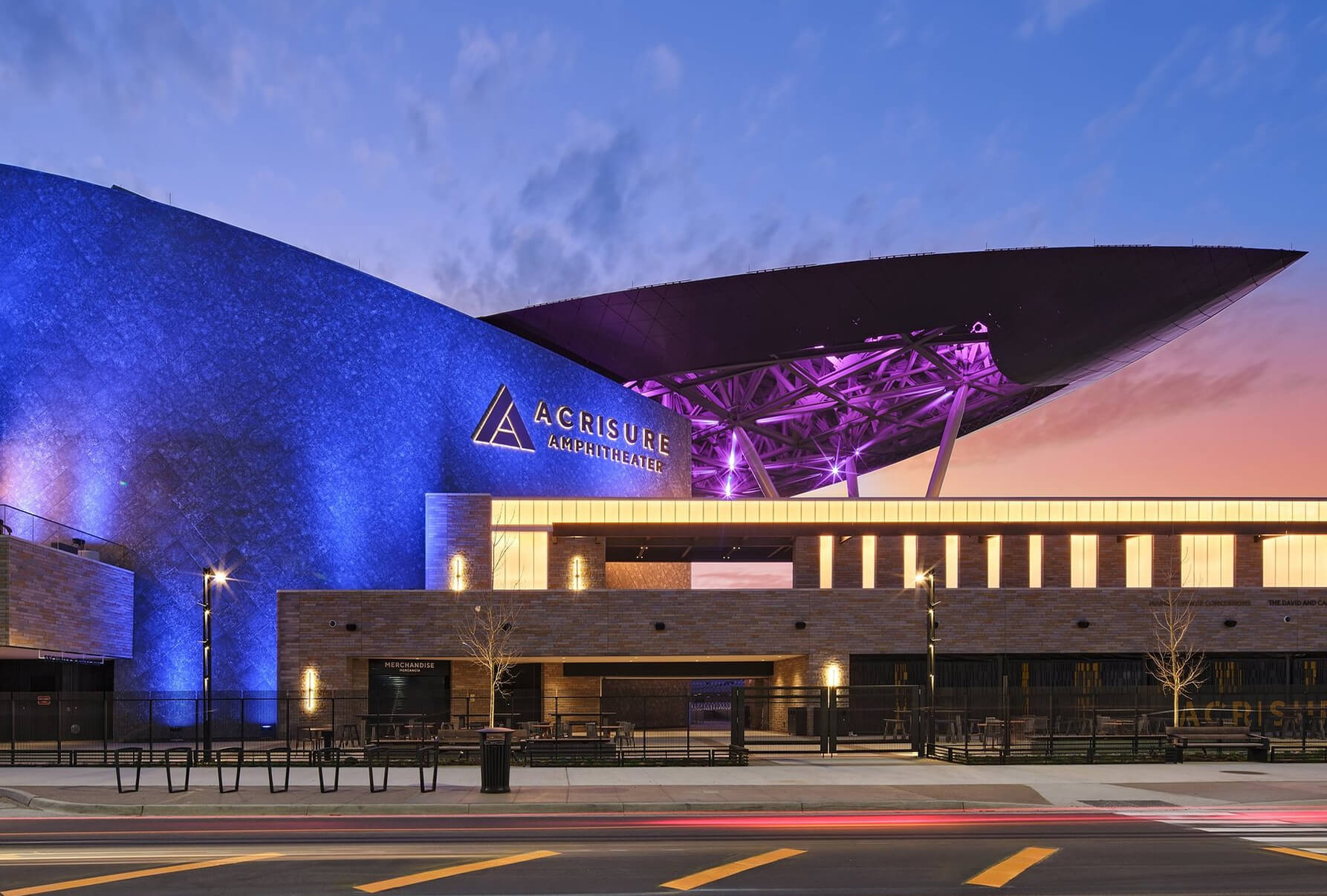 Exterior wayfinding and illuminated Acrisure Amphitheater identification signage integrated into the venue's contemporary architecture at dusk.