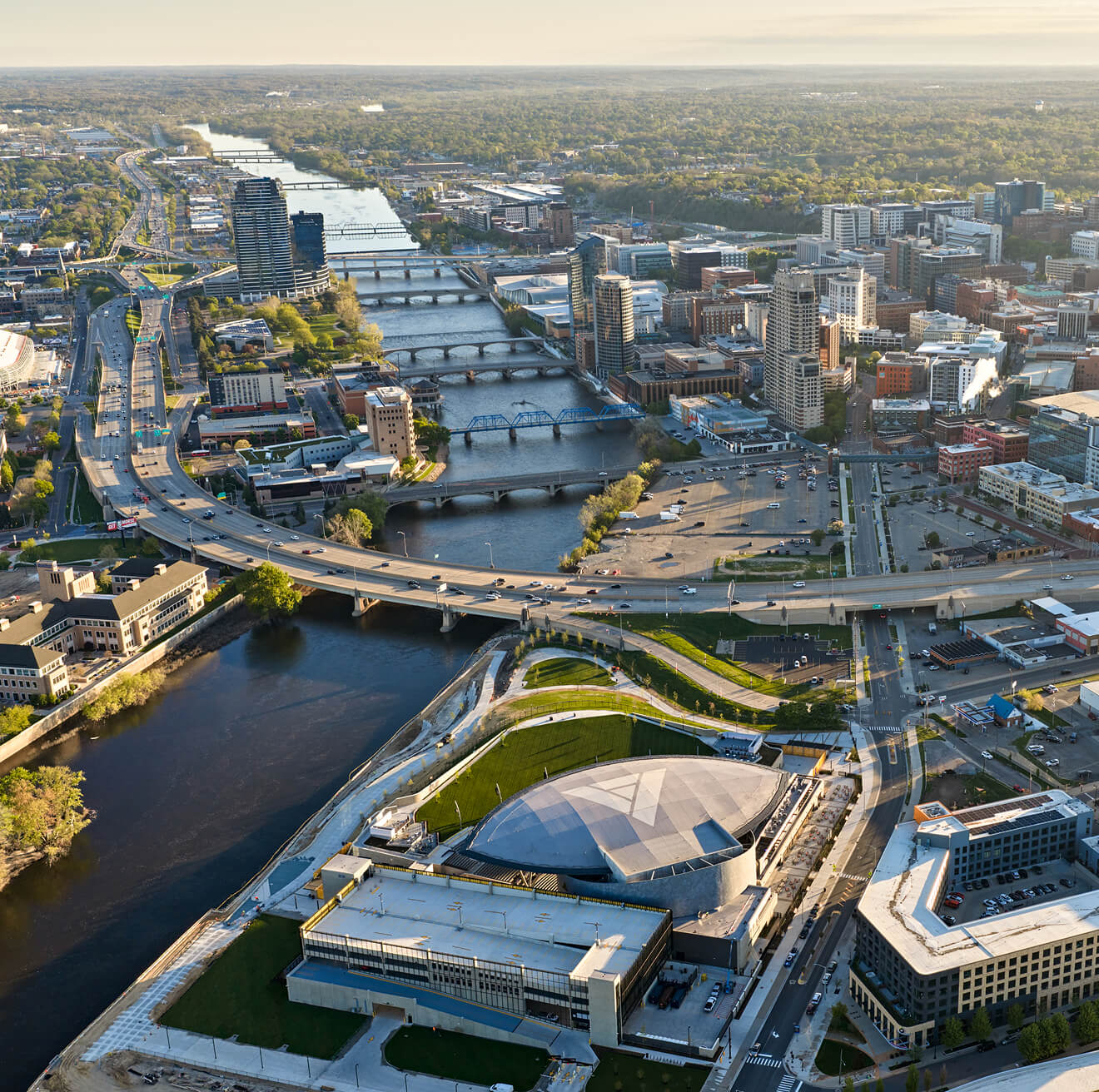 Aerial view of Acrisure Amphitheater and the Grand River running through Downtown Grand Rapids, MI