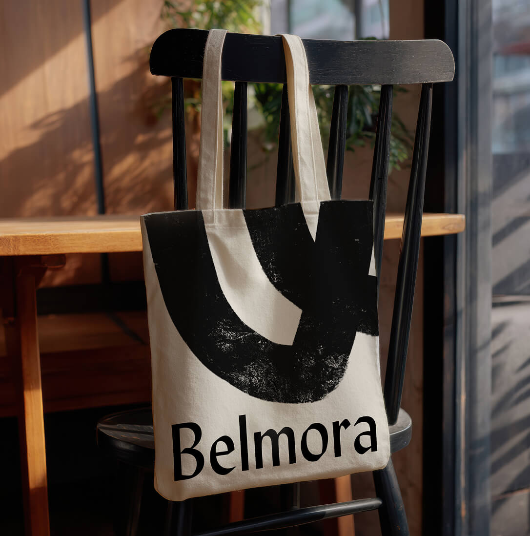 A branded tote bag hanging on a chair