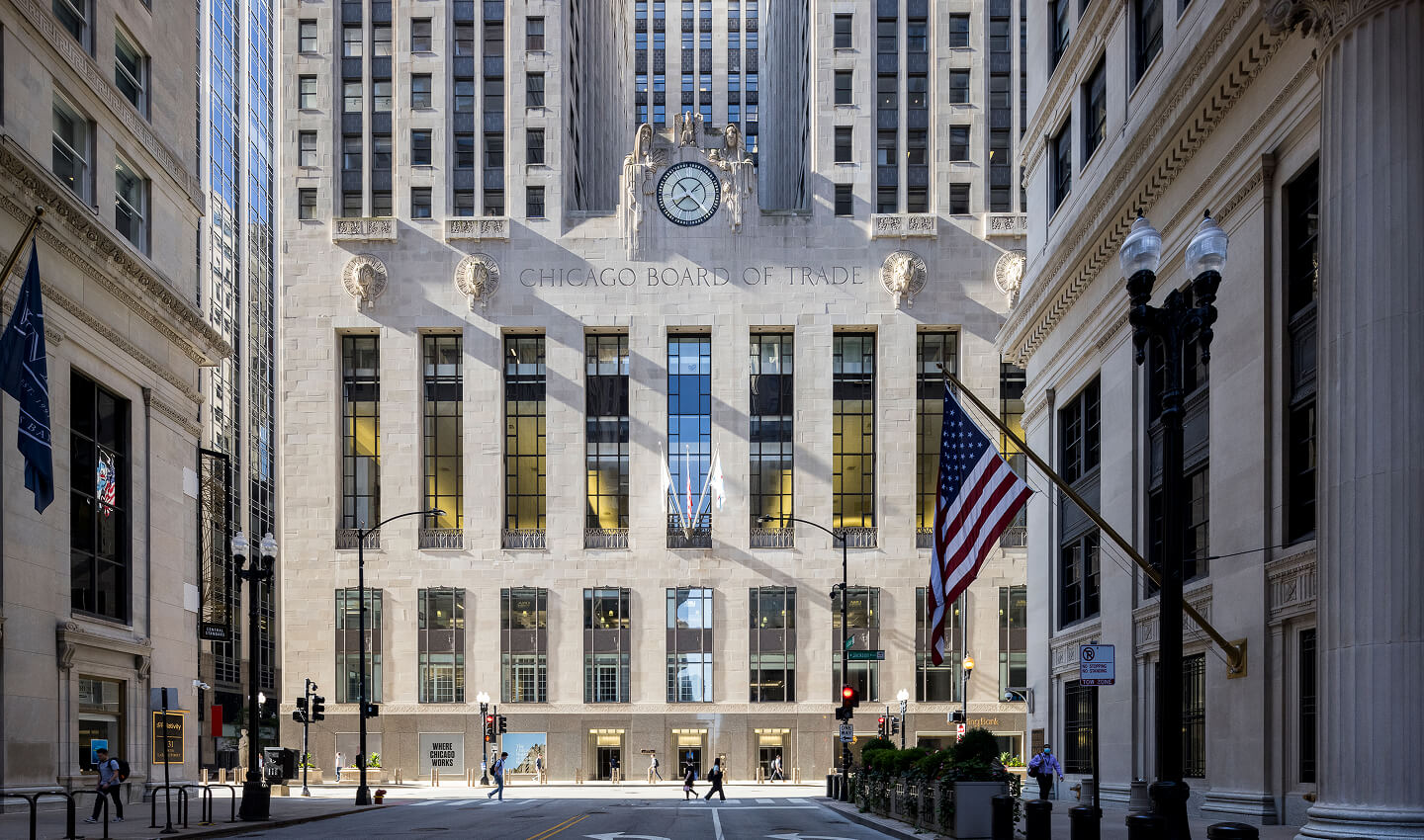 An exterior photo of The Chicago Board of Trade building, looking down LaSalle Street