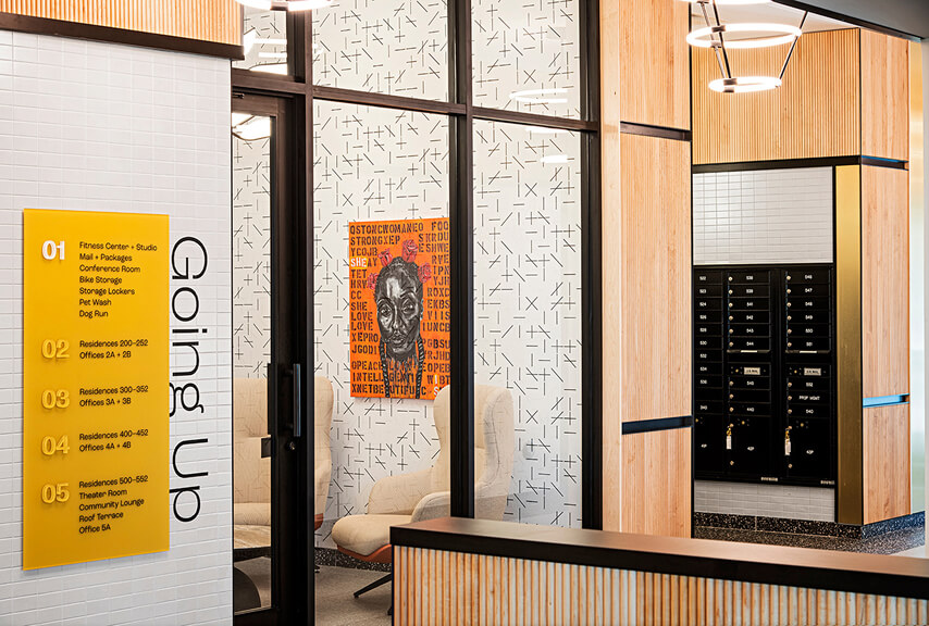 Interior of a high-end multi-family residential lobby with custom signage and wayfinding